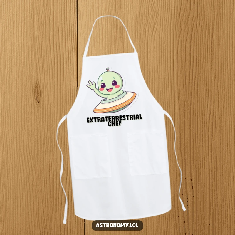 Funny alien apron featuring a smiling character waving from a spaceship, ideal for adding humor to cooking.