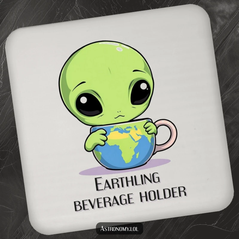 Funny alien drink coaster depicting a confused three-eyed creature staring at an Earth mug, adding humor to tabletops.