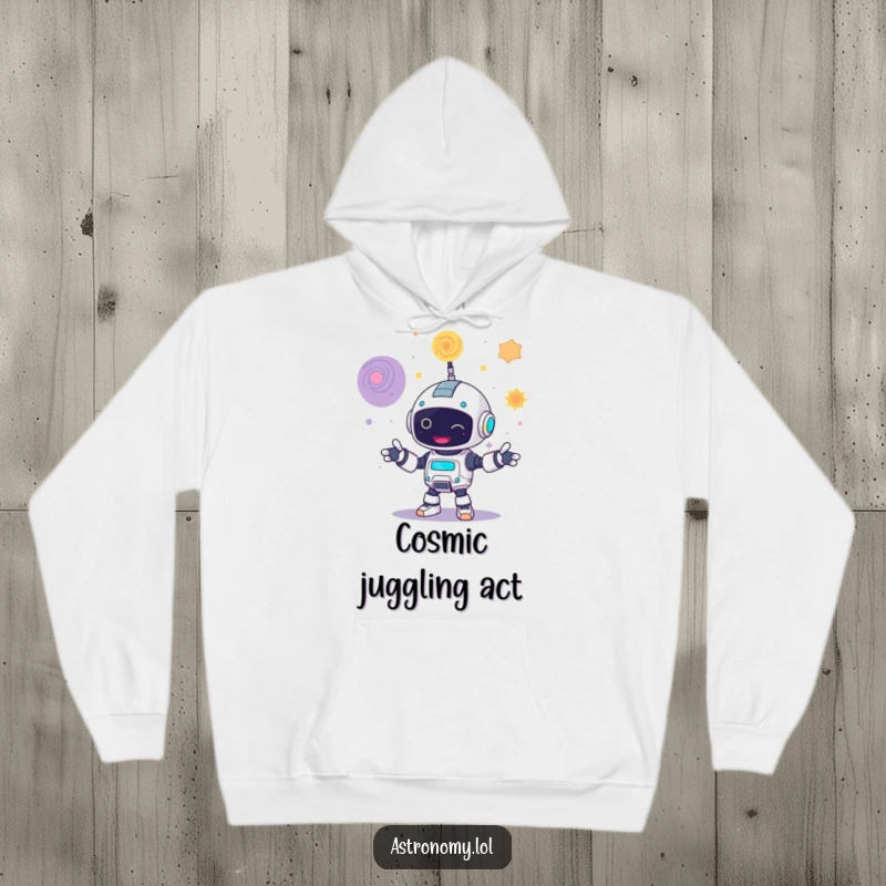 Funny hoodie with a giggling robot character juggling three mesmerizing, swirling galaxies, perfect for tech enthusiasts.