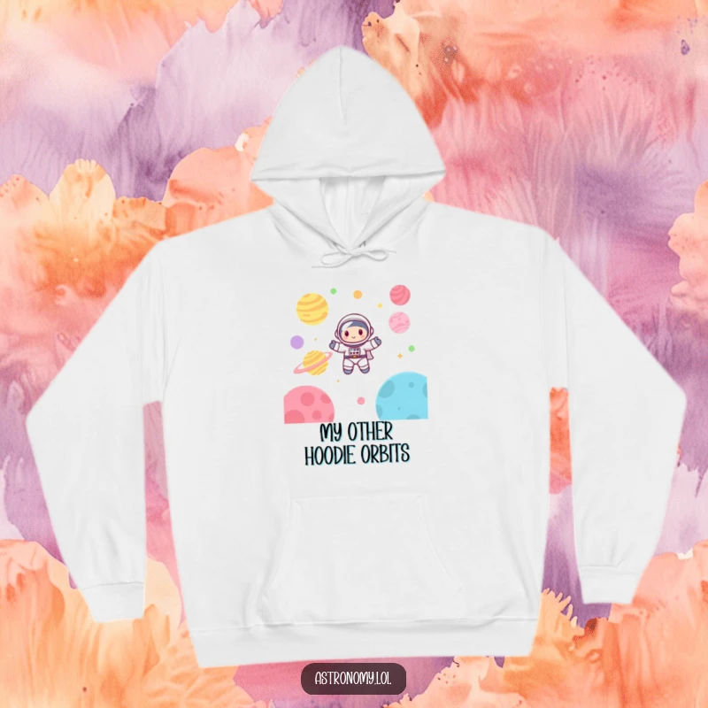 Funny astronaut hoodie showcasing a cute, happy character blissfully floating amidst colorful planets in a whimsical space setting.