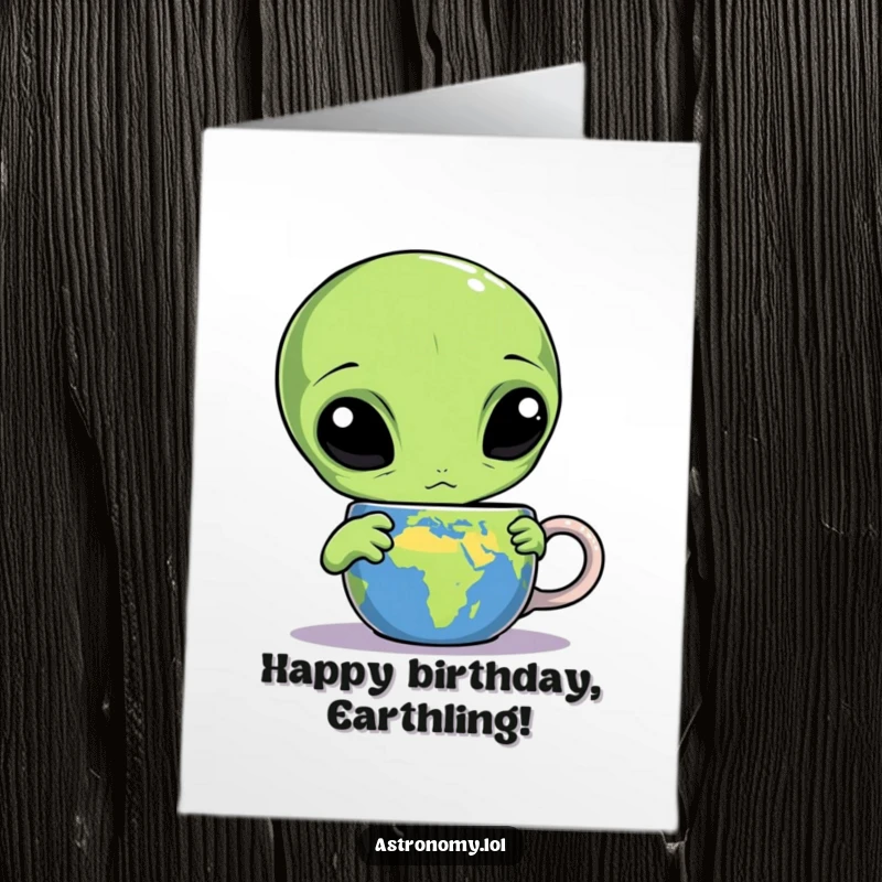 Funny Free Printable Birthday Card: Confused three-eyed alien stares bewilderedly at a mug labeled Earth.