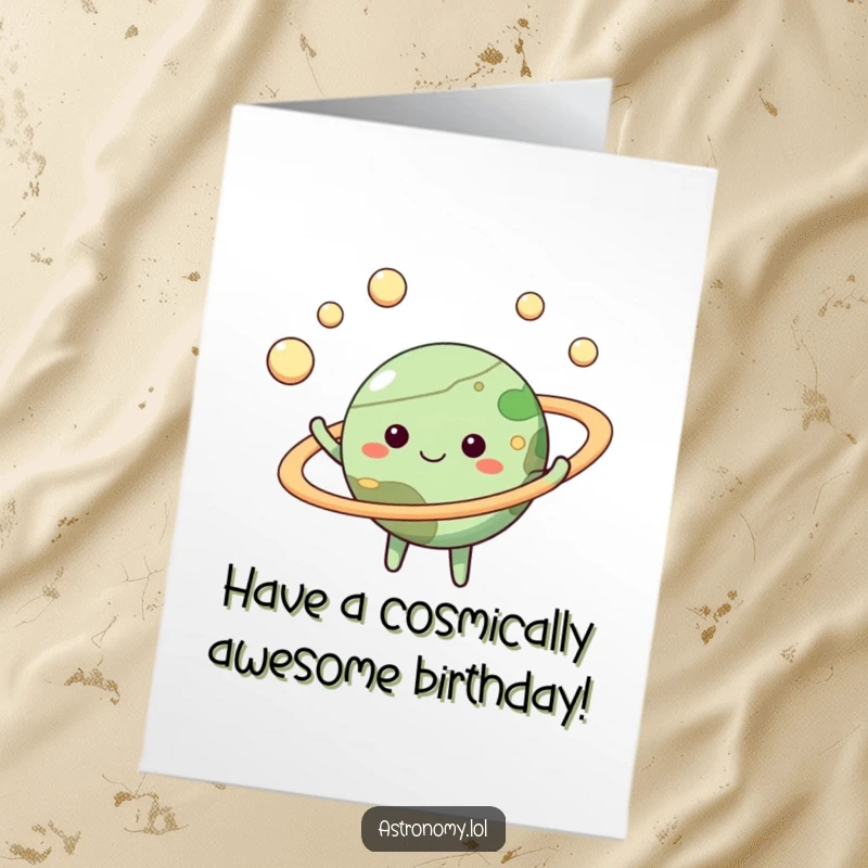 Happy Free Printable Birthday Card: Cheerful planet character expertly juggling tiny moons with its perfect rings.