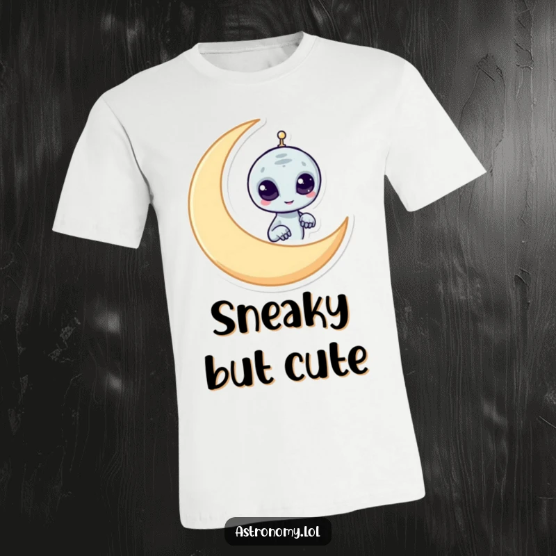 Funny alien t-shirt with a mischievous character peeking from behind a crescent moon, a humorous and cool design.
