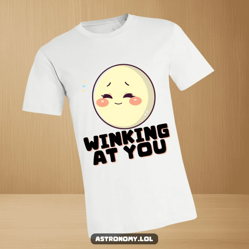Funny playful moon character winking slyly, printed on a comfortable and humorous t-shirt.