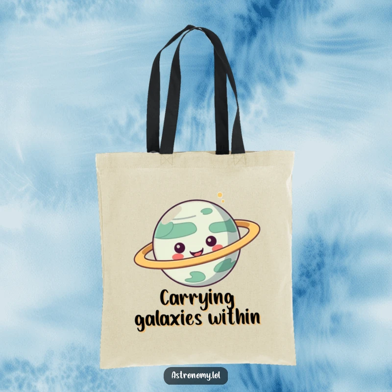 Funny tote bag featuring a playful planet character with spinning rings, perfect for carrying essentials with cosmic humor.