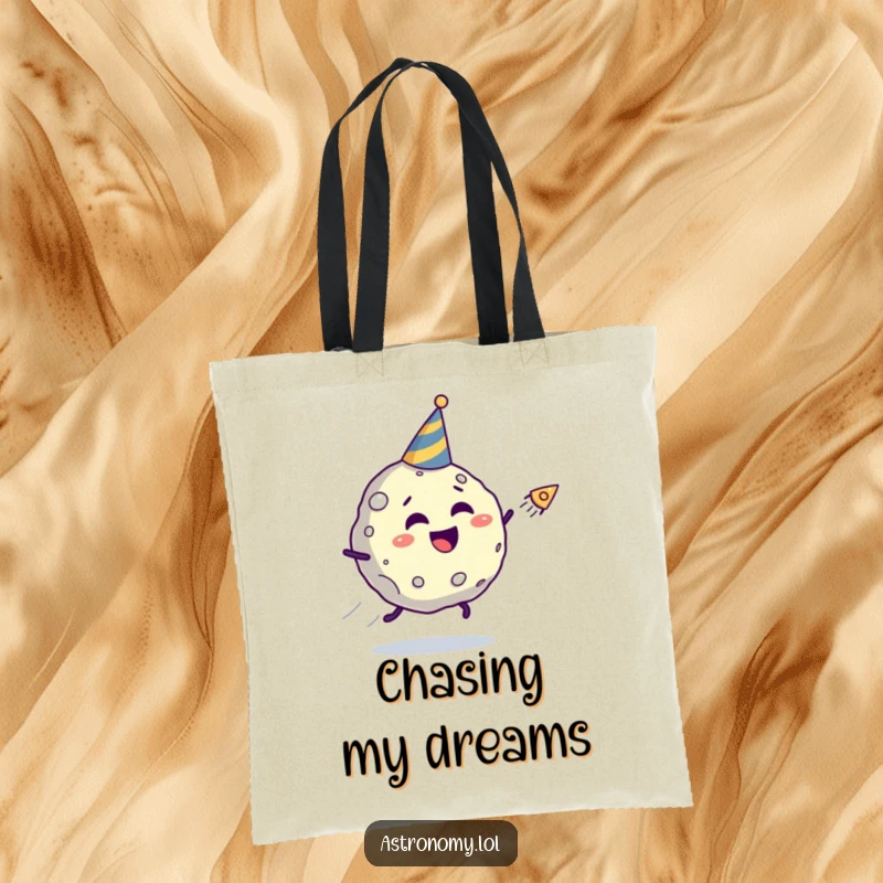 Funny asteroid tote bag featuring a giggling character in a party hat fleeing a comet, a humorous and practical accessory.